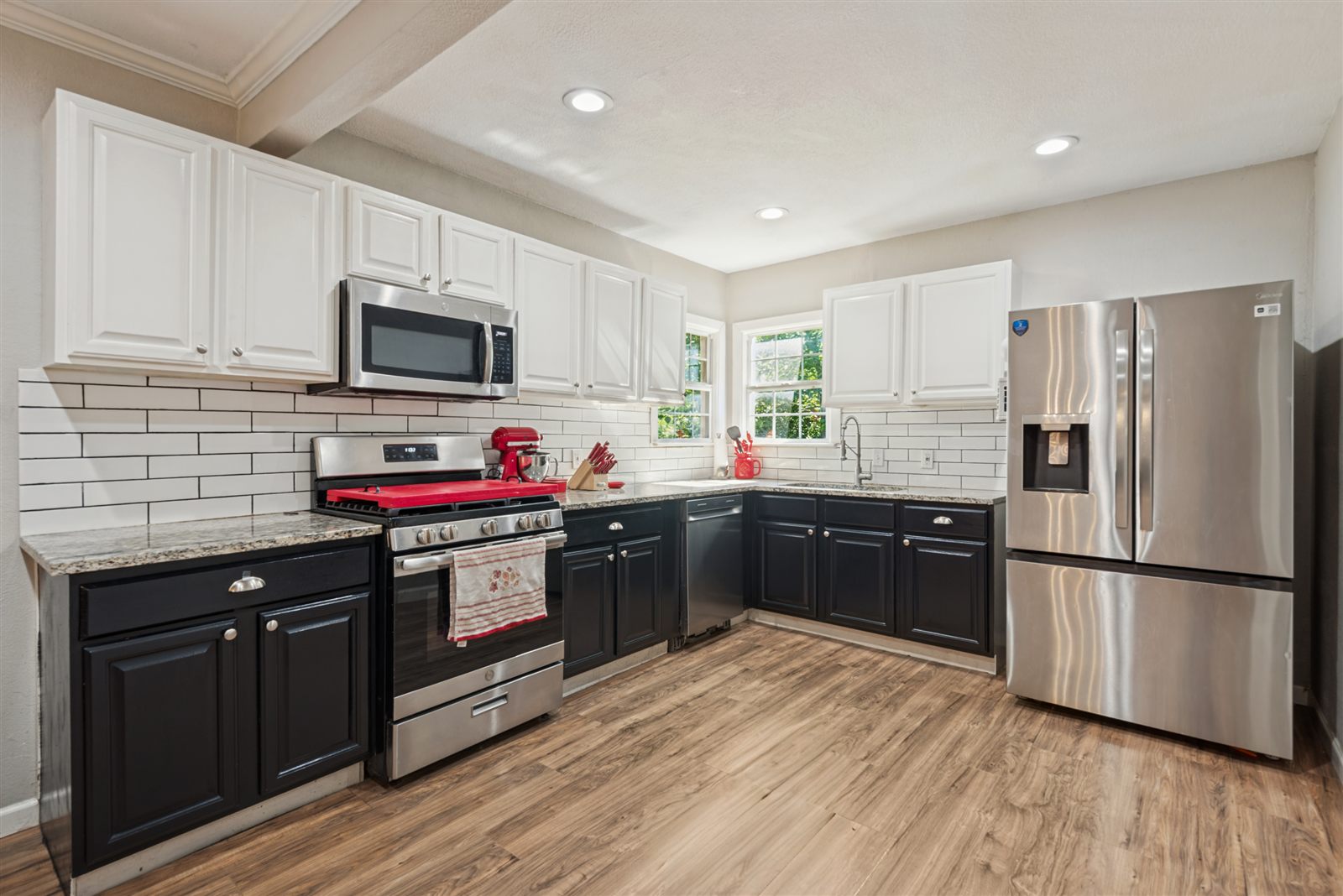 Kitchen with white uppers and stainless appliances